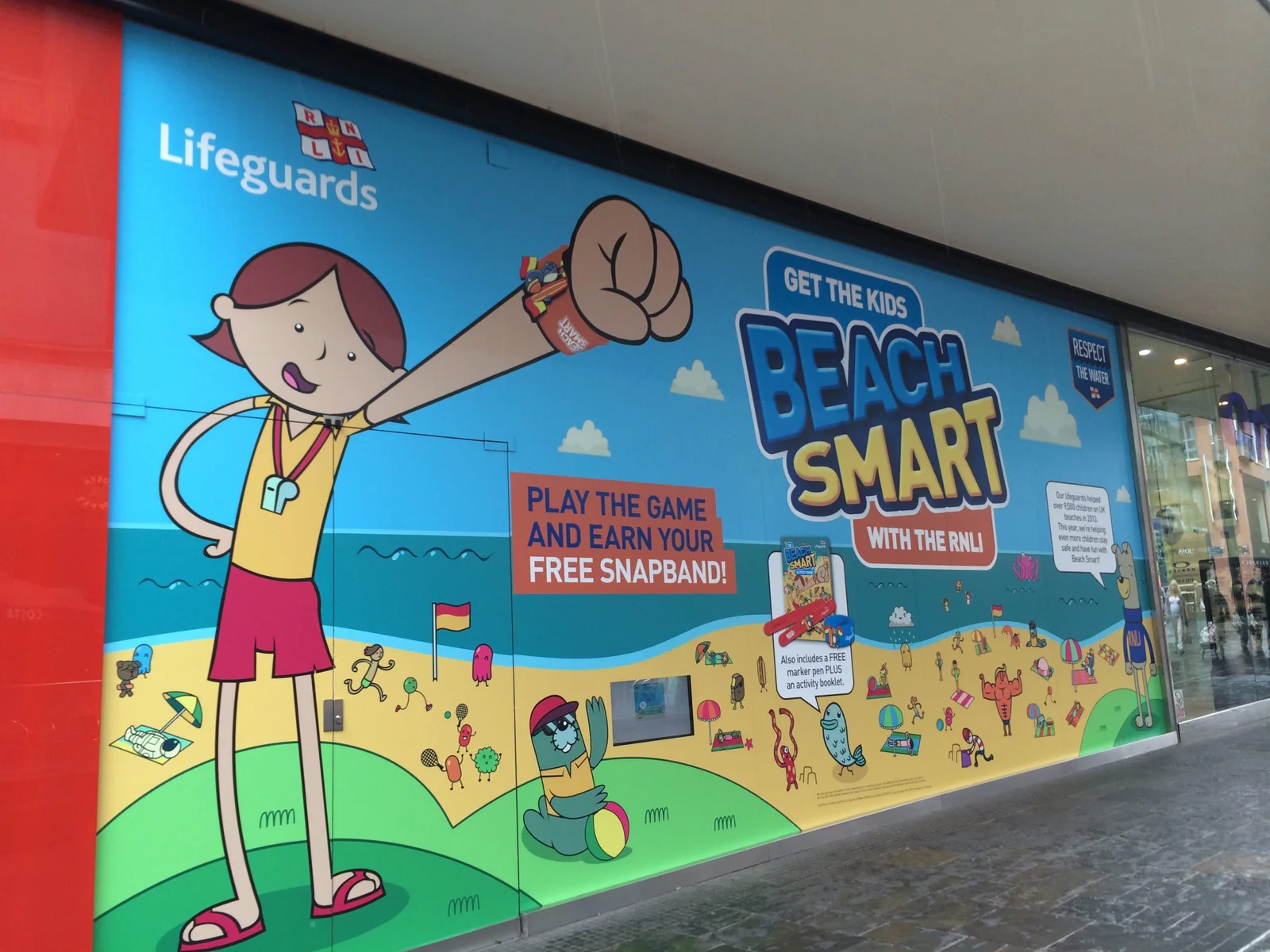 A public RNLI Beach Smart campaign activation with colourful safety messaging.